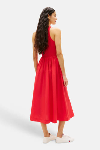 Robe rouge sans manches de TOMMY JEANS, avec jupe mi-longue et baskets blanches.