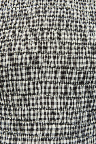 Manteau blanc à manches courtes d'ENVII, avec un motif smock rayé noir et blanc.