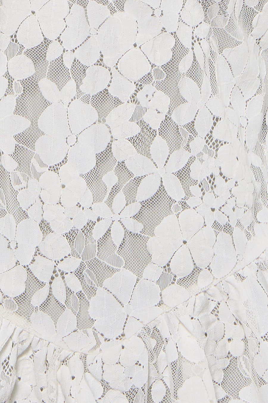 Chemisier blanc d'ENVII, avec dentelle florale et bord à volants, gros plan.