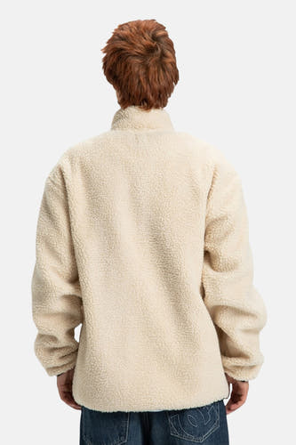 Manteau court beige de DC SHOES, avec une texture cotonneuse, vu de derrière.