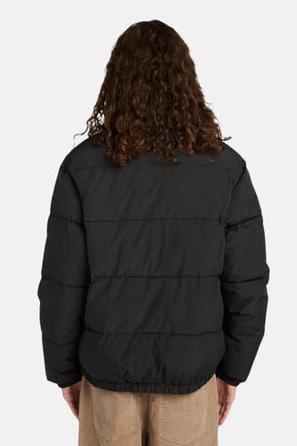 Manteau court noir d'ELEMENT, vue arrière, avec de longs cheveux bouclés bruns et un pantalon en corduroy.