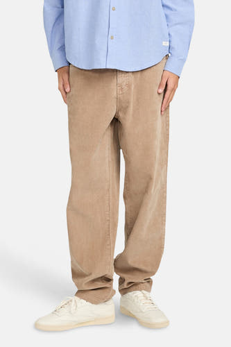 Pantalon beige d'ELEMENT, avec des jambes larges et des chaussures claires.