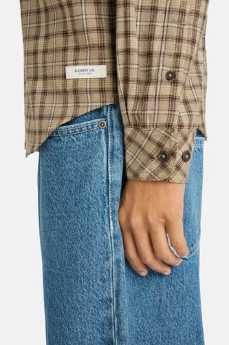 Chemise beige à manches longues d'ELEMENT, avec un motif de carreaux et des détails de boutons, portée sur un jean.