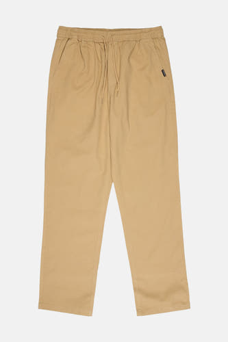Pantalon beige Quiksilver, avec une taille élastique et un cordon de serrage.