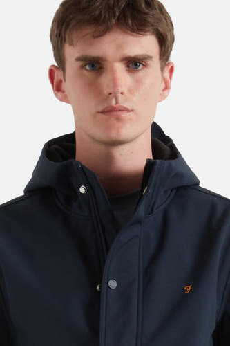 Manteau court bleu de FARAH, avec capuche et boutons imprimés argentés.