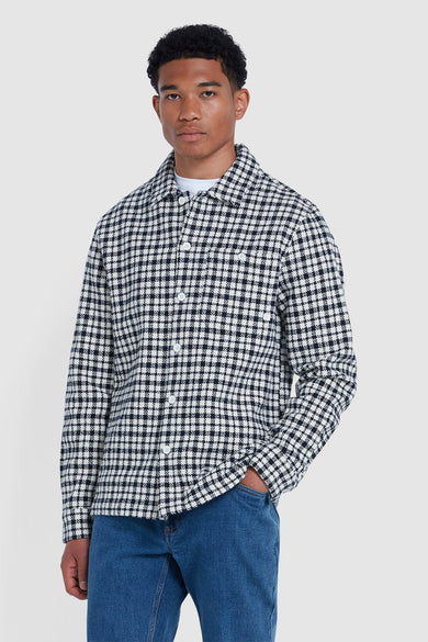 Blauw hemd met lange mouwen van FARAH, met een zwart-wit ruitpatroon en gedragen over een wit T-shirt.