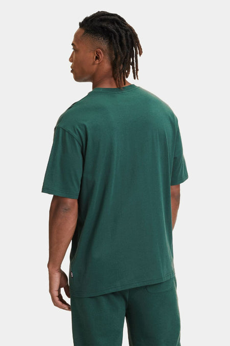 T-shirt vert de mantes courtes FILA, vu vu d derrière, avec une couleur unie et une coupe décontractée.