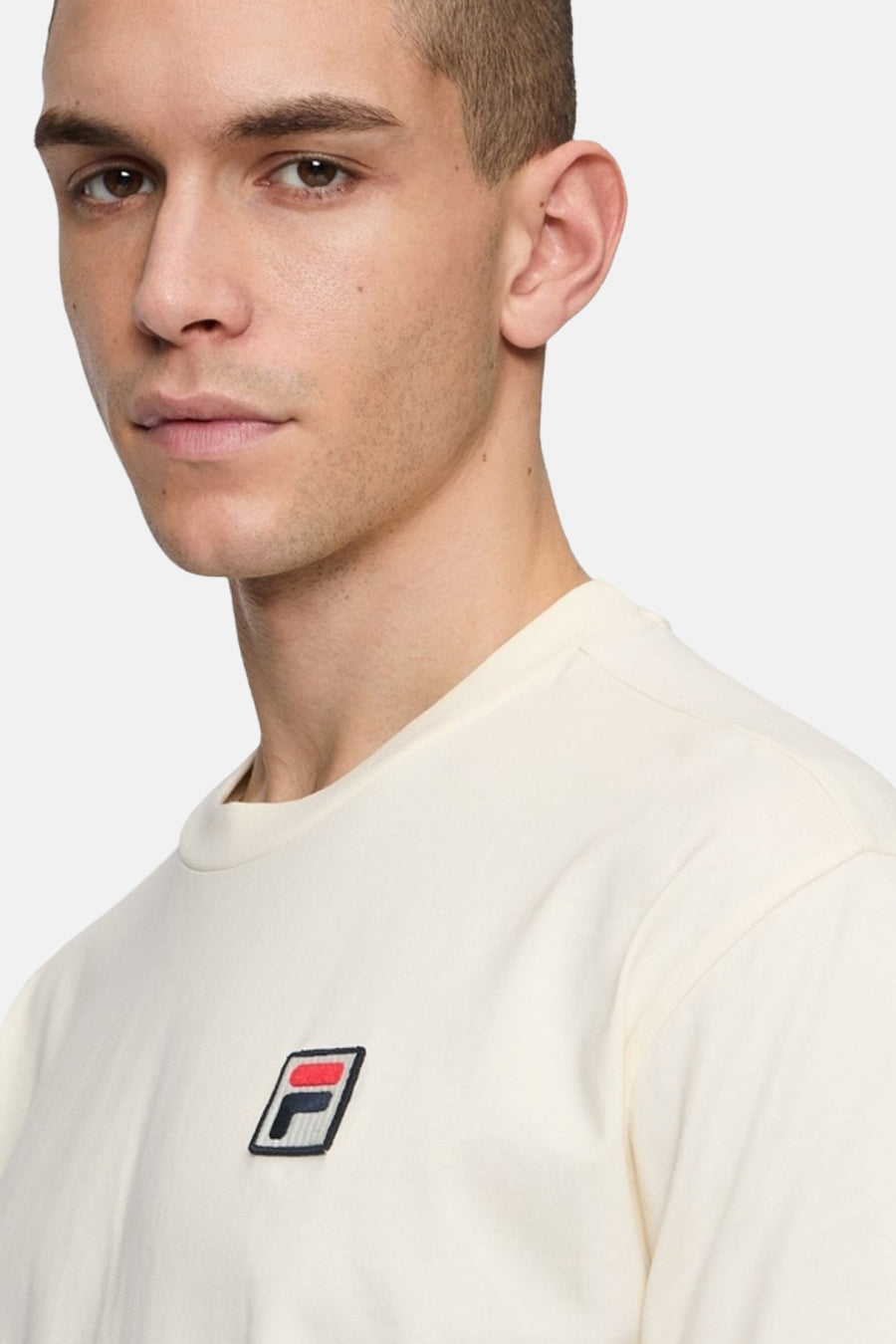 T-shirt écru de FILA à manches courtes, avec un petit logo sur la poitrine.