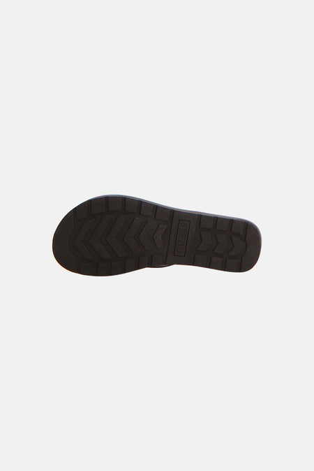 Tongs noirs Guess avec semelle crantée épaisse et logo Guess vertical.