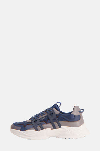 Sneakers bleues de Guess, avec des accents gris et une semelle chunky blanche.
