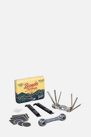 Kit de réparation de vélos multicolore de Gentlemen's Hardware, avec outils et matériaux adhésifs sur un fond blanc.