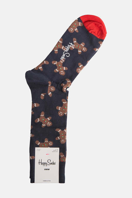 Chaussettes bleues foncées avec des motifs de gâteaux d'Hiver Happy Socks, avec une che rouge et un étiquette blanche.