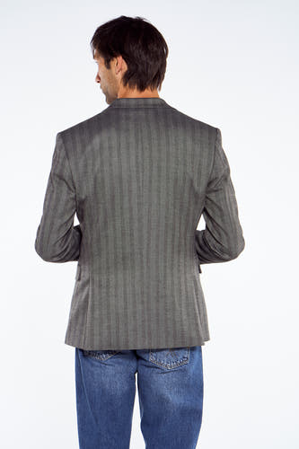 Blauwe blazer van Le Fabuleux Marcel de Bruxelles, met een subtiel visgraatmotief en gecombineerd met spijkerbroek.