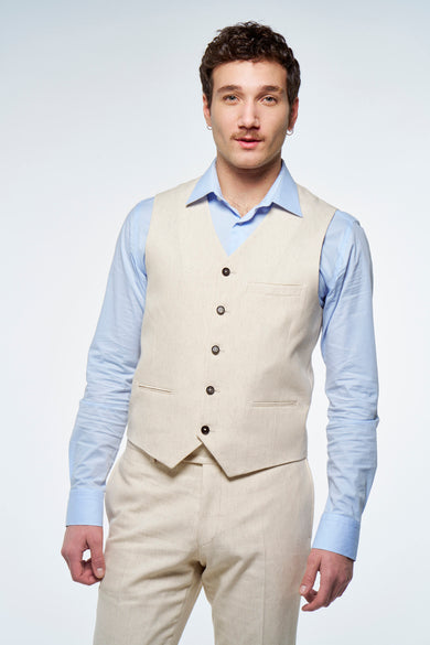 Man in lichtblauw overhemd en beige linnen pak.