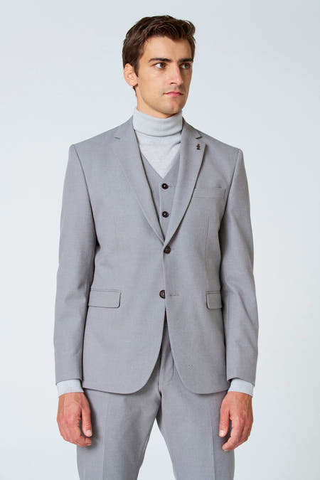 Blazer beige de Le Fabuleux Marcel de Bruxelles, avec des strass et une doublure à motifs géométriques.