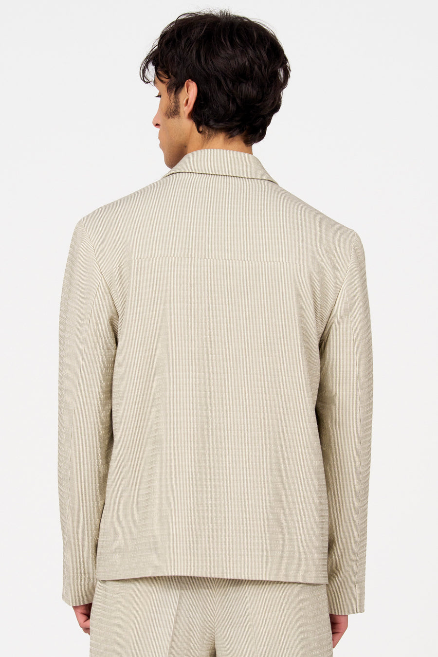 Beige blazer van Le Fabuleux Marcel de Bruxelles, gezien van achteren, met een fijn verticaal streepjespatroon.