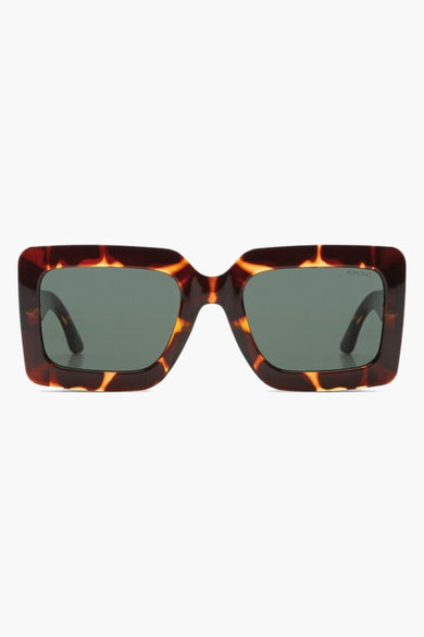 Lunettes de soleil brunes de KOMONO, avec un cadre tortue et des verres sombres.