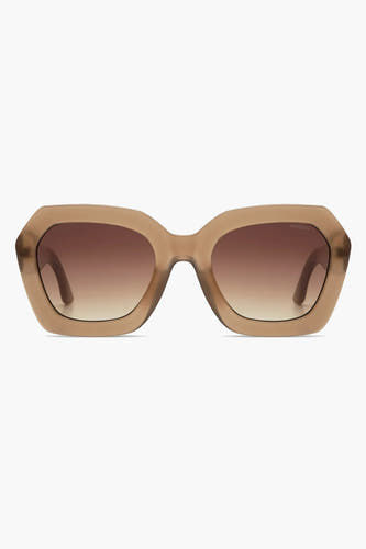 Lunettes de soleil beige de KOMONO avec une transition de couleur marron à transparent dans les verres.