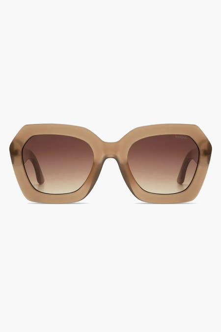 Lunettes de soleil beige de KOMONO avec une transition de couleur marron à transparent dans les verres.
