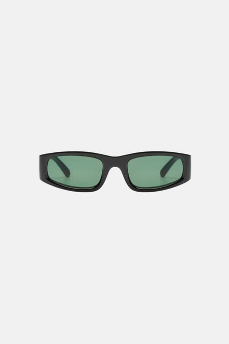 Lunettes de soleil noires KOMONO, avec verres verts et monture rectangulaire.