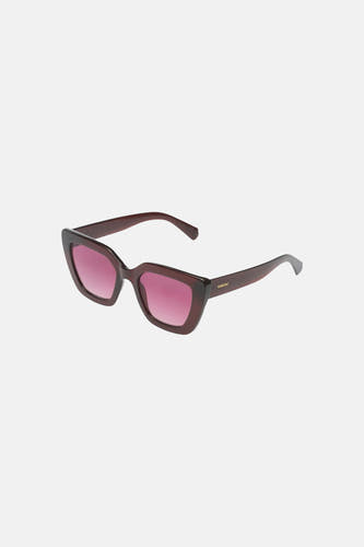 Lunettes de soleil angulaires marron foncé-rouge de KOMONO avec verres dégradés roses et un logo sur la branche.
