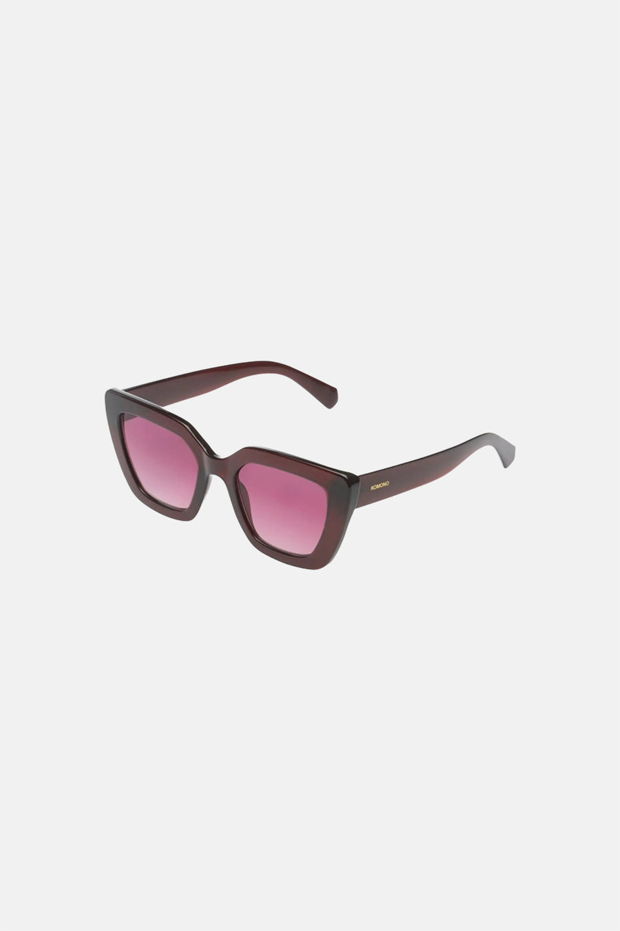 Lunettes de soleil angulaires marron foncé-rouge de KOMONO avec verres dégradés roses et un logo sur la branche.