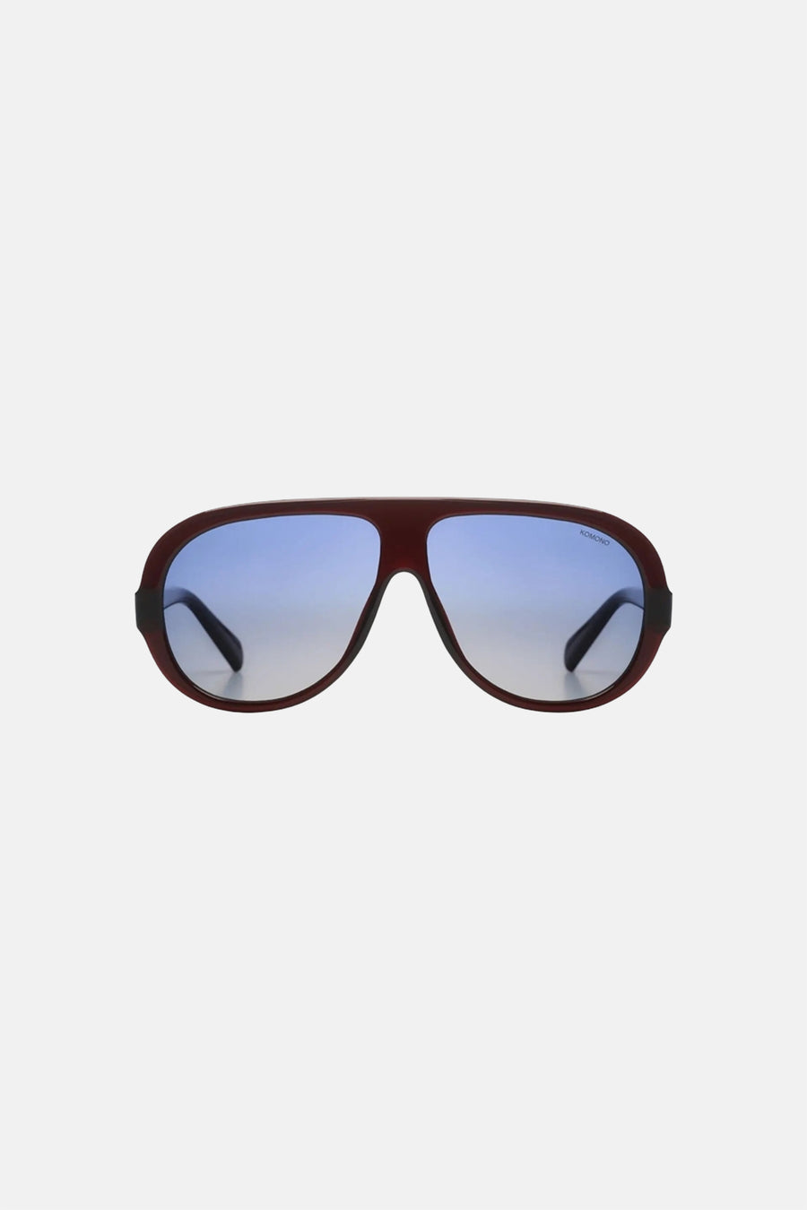 Lunettes rouge-brun de KOMONO avec verres à dégradé bleu et logo.
