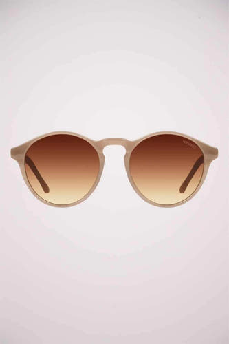 Lunettes de soleil beige de KOMONO, avec verres teintés marrons et montures arrondies.