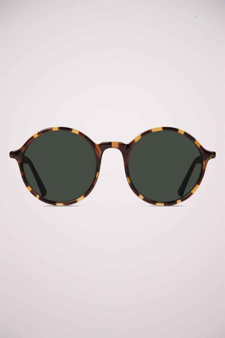 Lunettes de soleil vertes de KOMONO, avec un cadre en motif tortue.