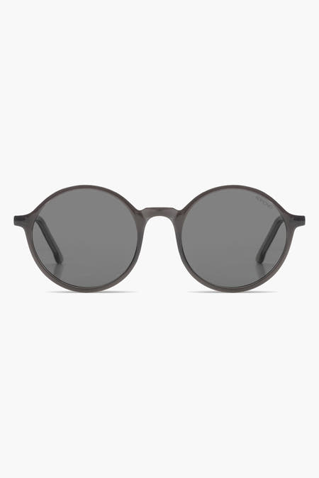 Lunettes de soleil grises de KOMONO avec un cadre élégant et des verres foncés.