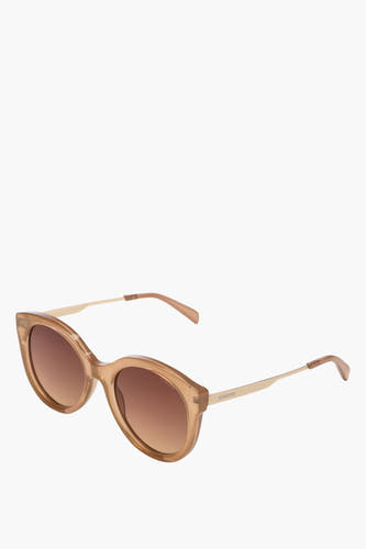 Lunettes de soleil beige de KOMONO, avec des branches dorées et des verres marrons.