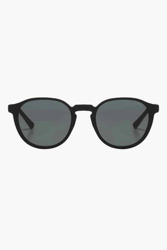 Lunettes de soleil noires KOMOMONO, avec un cadre rond et des verres foncés.