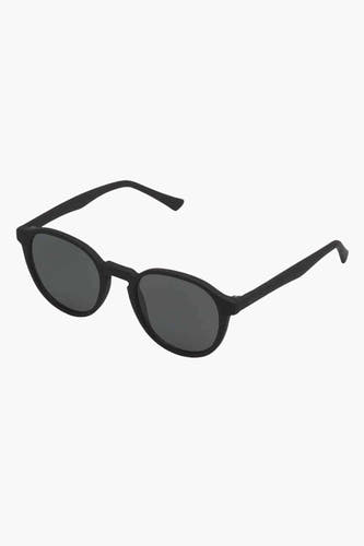 Lunettes de soleil noires KOMOMONO, avec un cadre rond et des verres foncés.