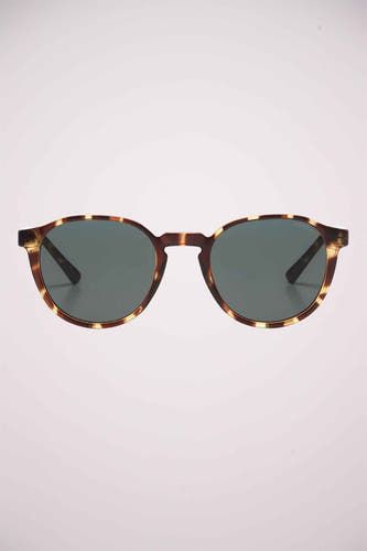 Lunettes de soleil vertes de KOMONO avec un cadre en motif tortue.