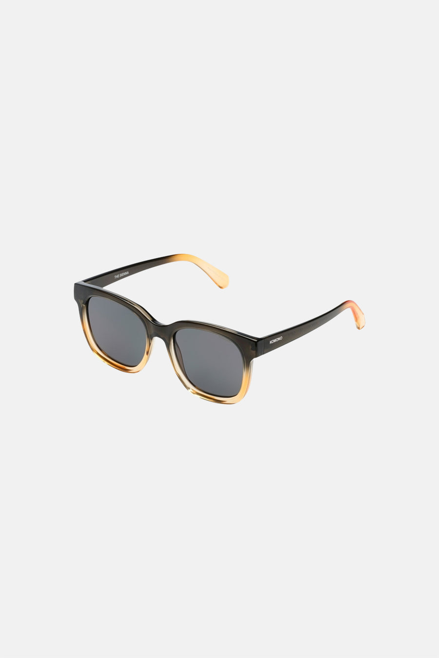 Lunettes de soleil marron de KOMONO, avec une monture dégradée de foncé à clair et des verres foncés.
