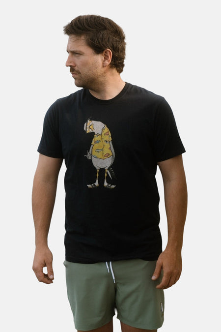 T-shirt noir à manches courtes de LAKOR, avec une illustration d'une figure en chemise jaune.