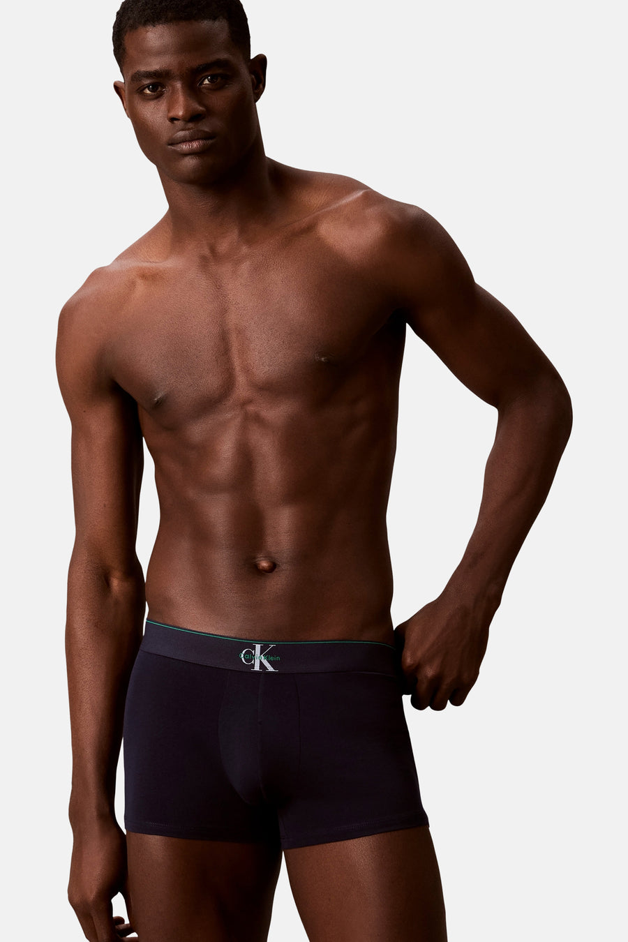 Boxer noir Calvin Klein, porté par un mannequin masculin torse nu, debout sur un fond blanc.