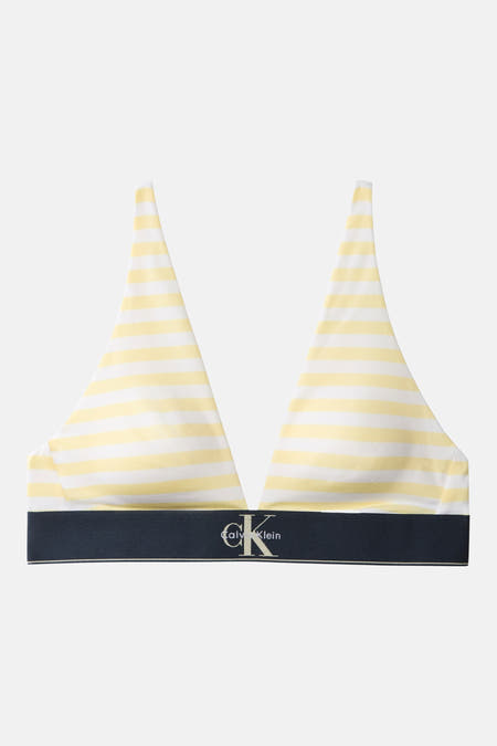 Soutien-gorge jaune à rayures de Calvin Klein avec des rayures blanches et une bande logo bleu foncé.