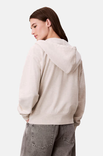 Gilet beige de Calvin Klein, vu d de lrière avec avec un capuchon et des jeans gris.