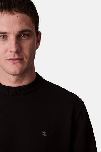 Gilet noir de Calvin Klein, avec un col rond et un petit détail de logo.