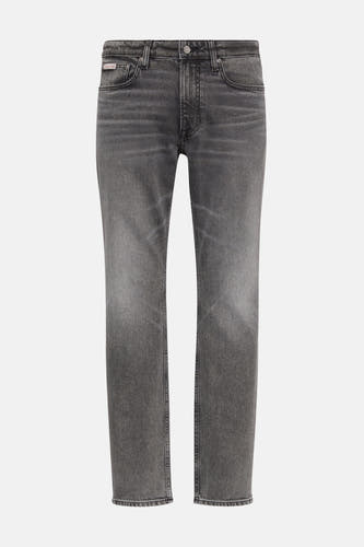 Jean slim gris de denim par Calvin Klein, avec un lavage subtil.