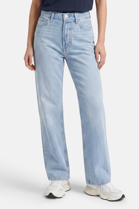 Lichtblauwe straight jeans van Calvin Klein, met gewassen denimlook, zichtbare zakken en klassieke vorm, gedragen met witte sneakers.