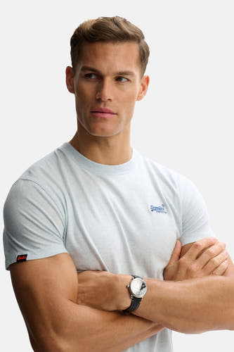 Blauwe korte mouw T-shirt van SUPERDRY met klein logo op borst, zichtbaar op model met gekruiste armen