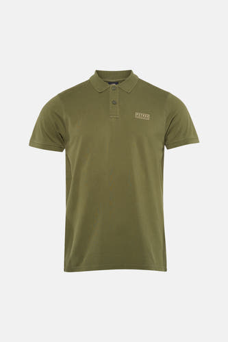 Polo verte de Petrol Industries à manches courtes avec un patch logo, combinée avec un jean bleu et des baskets blanches.