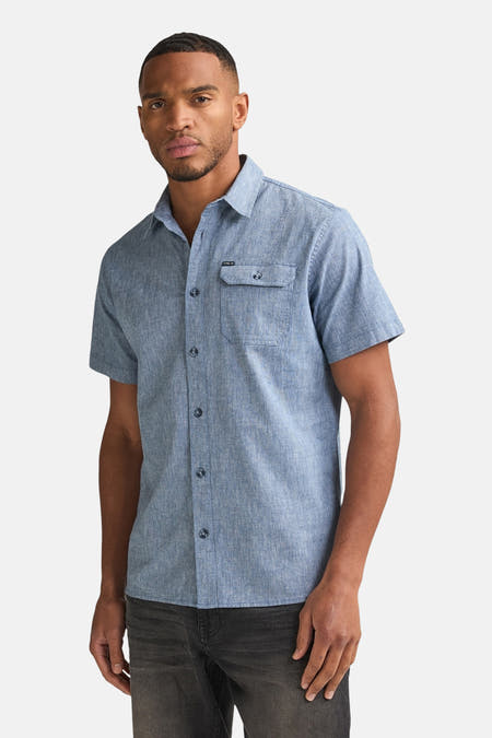 Chemise bleue à manches courtes de Petrol Industries, avec fermeture boutonnée et poche poitrine.