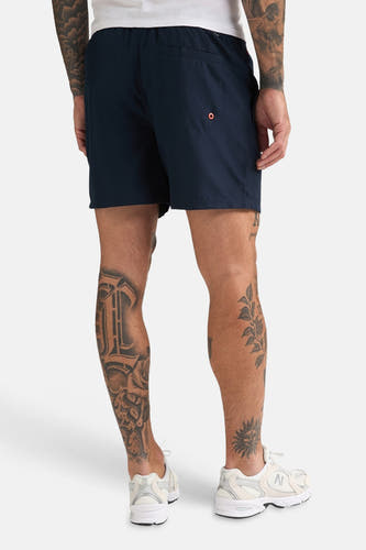 Blauwe zwemshort van Petrol Industries®, met een achterzak met oranje detail.