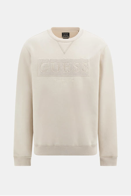 Pull écru à col rond de Guess, avec logo Guess brodé ton sur ton et bords côtelés.