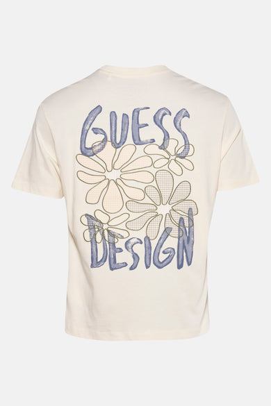 T-shirt écru à manches courtes de Guess avec des fleurs et une impression "Guess Design" sur l'arrière.