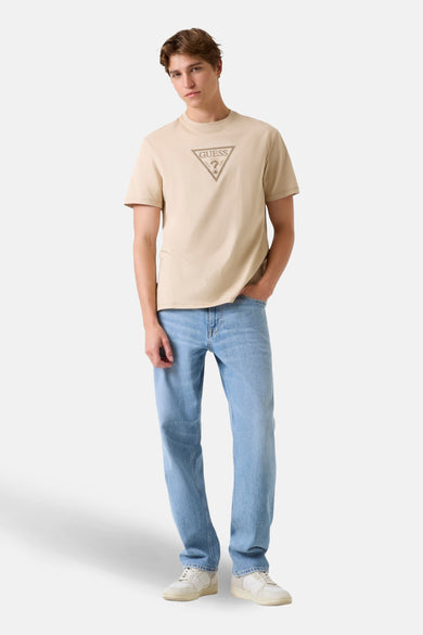 T-shirt beige à manches courtes de Guess, avec un logo sur la poitrine, à combiner avec un jean et des baskets.