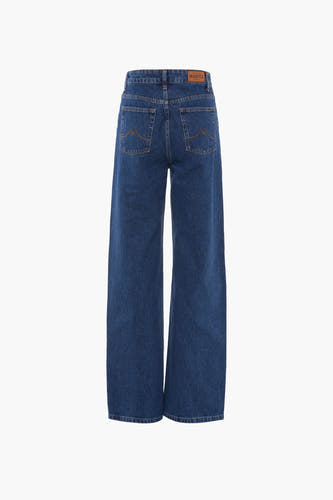Jean wide bleu foncé de Le Fabuleux Marcel de Bruxelles, avec des boutons caractéristiques sur les poches arrière.